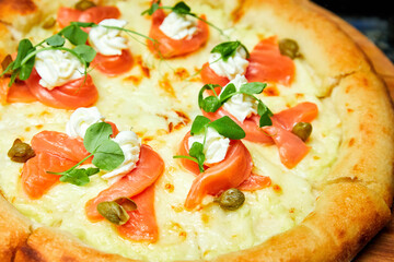 Pizza with salmon and cream cheese. Close-up, selective focus