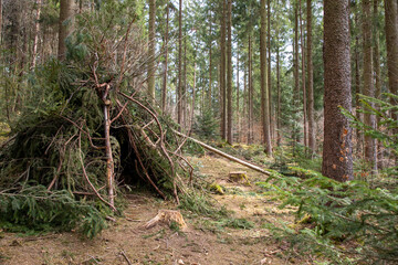 Tipi in a forest made out of branches and leaves. Adventure Trail in Freising