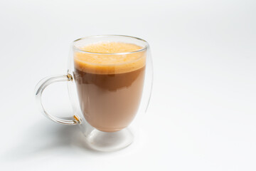 Double walled glass mug with coffee and vegan milk on white, close-up view.