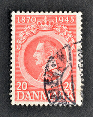 Cancelled postage stamp printed by Denmark, that shows portrait of King Christian X, 75th birthday, circa 1945.