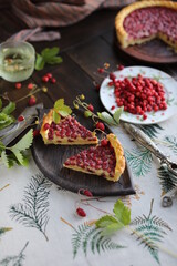 Two pieces of pie. Open almond tart with wild strawberries on a table with a tablecloth. Homemade cakes with hand-picked seasonal berries.