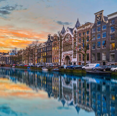 Long exposure shot of beautiful Dutch buildings during dusk in Amsterdam, Netherlands