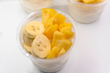 Bowl of fresh yogurt with fruit served for good health.