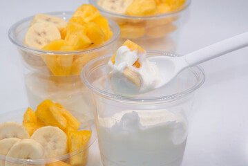 Naklejka na ściany i meble Bowl of fresh yogurt with fruit served for good health.