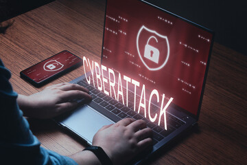 Woman use laptop with cyberattack warning on screen. Cyber security data protection business...