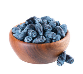 Honeysuckle berries in wooden bowl, isolated on white background. Ripe berries of honeysuckle. Clipping path.