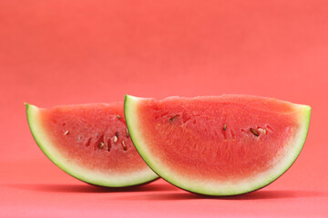 slice of fresh watermelon isolated on red background