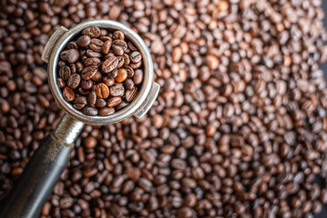 Tamped puck of coffee and blur coffee bean background