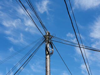 Old wooden post with cables and wires