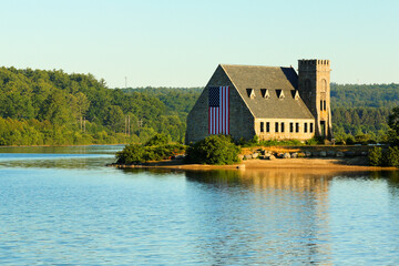 Fototapeta na wymiar The Old Stone Church and Wachusett Reservoir at West Boylston at sunrise, Massachusetts. The Church, built in 1891, is a historic building in Boylston and is a National Resisted Historic Place.