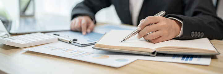 Business woman analyzing data paperwork calculating numbers..