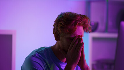 Disappointed gamer losing cyber battle closeup. Upset ginger man taking headset  © stockbusters