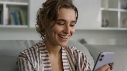Smiling student enjoy watching video blog at home closeup. Focused app customer 