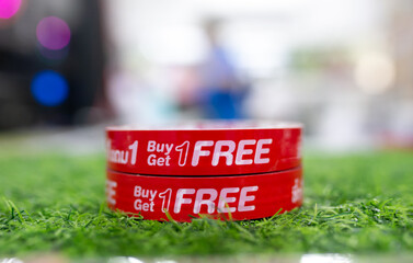 buy one get one free sale label on red tape.