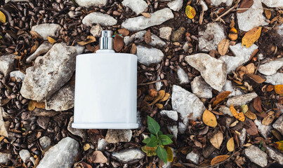 white perfume on the ground with white stones on the ground