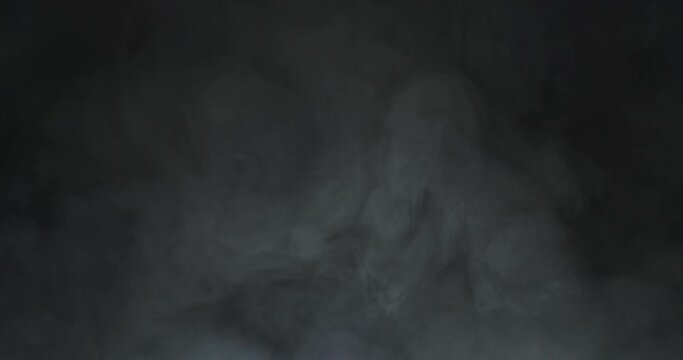 Realistic atmospheric gray smoke on black background.
