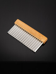 curly knife next to sliced vegetables with a wavy edge