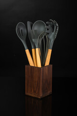 wooden stand with kitchen utensils, spoon, skimmer, ladle, spatula