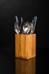 wooden stand with kitchen utensils, spoon, fork, knife
