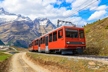Obraz premium Beautiful view of the Swiss Alps with cogwheel train of Gornergrat railway close to Zermatt, Switzerland