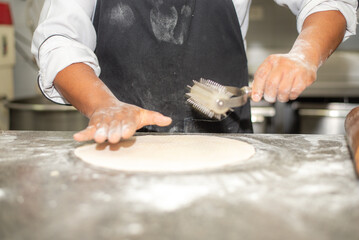 Hands of person rolling a dough for the cookies in flour.1