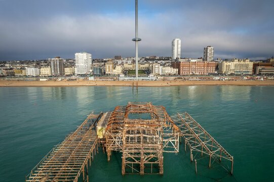 Remains of the West Pier against Brighton cityscape. England, United Kingdom.