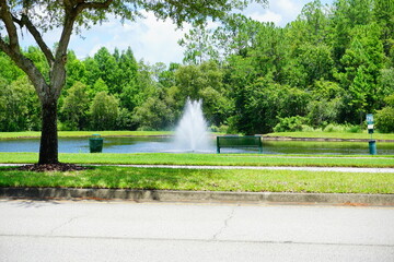 A Florida community pond and water front bench 
