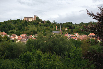 Fototapeta na wymiar The old castle Gamburg on the top of the hill. With the village Gamburg and the river Tauber in the foreground.
