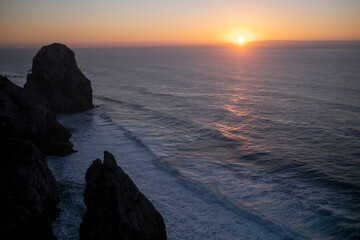 View of the Atlantic ocean cliffs during sunset, Portugal.