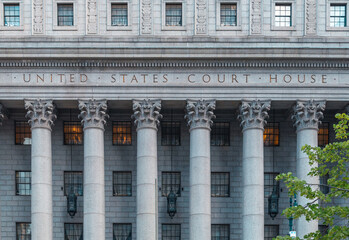 The main entrance of the Thurgood Marshall US Courthouse in NYC is listed on the National Register of Historic Places. The Corinthian columns and the frieze are carved with a detailed floral design. - obrazy, fototapety, plakaty