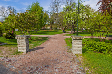 Beautiful view of entrance to natural green park on bright summer day. Sweden. 