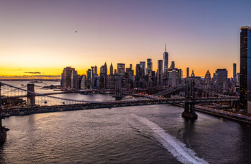 Aerial panoramic view of Manhattan bridge, important thoroughfare across East River. Skyline with downtown skyscrapers at sunset. Manhattan, New York City, USA