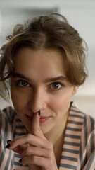 Fototapeta na wymiar Beautiful woman making silence gesture closeup. Blonde girl sharing secrets 