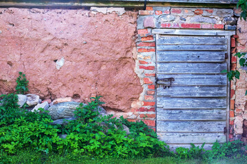 
old clay wall with old wooden door