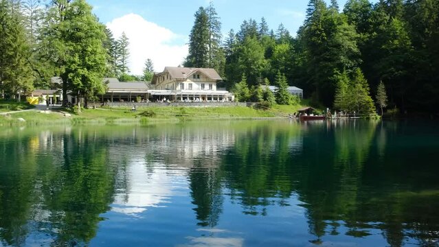 A handheld with noise effect of Blausee lake taken in the morning. It is located in the midst of a 20 hectare large nature park with a landscape formed by a rock slide that led to the.