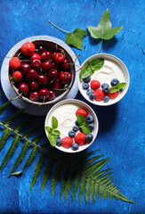Sweet cherry on a table. Vibrant color of summer fruit. Refreshing summer snack. Top view photo of cherry. 