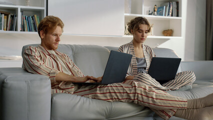 Serious couple working home together closeup. Managers browsing at remote office