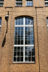 Large windows of the old factory building. Exterior view