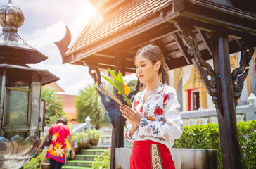 Beautiful Asian girl at big Buddhist temple dressed in traditional costume