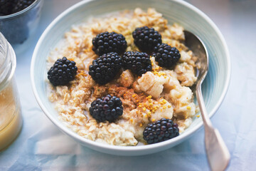 Bowl of porridge with bananas and blackberry and cinnamon 