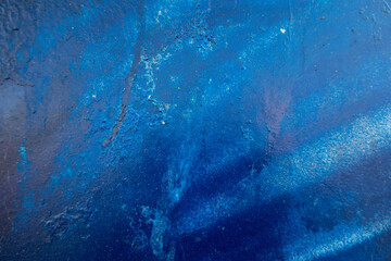 Blue painted stucco concrete with leaking traces of paint. Abstract old grunge wall texture background