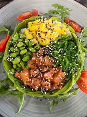 healthy salmon, seaweed, mango and green bean salad top view