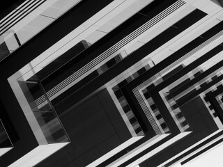 Grayscale shot of an abstract modern geometric building with sharp-edged balconies