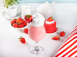 Glass of strawberry milkshake or smoothie. Summer healthy vitamin beverage, diet or vegan food