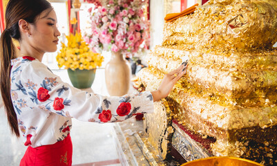 Beautiful Asian girl at big Buddhist temple dressed in traditional costume