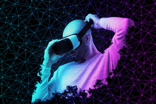 Metaverse. Young bald man put on VR glasses. Black background with neon abstract mesh. The concept of virtual reality and cyberspace