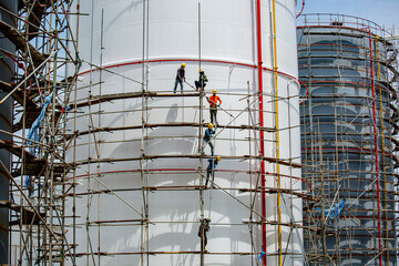 Fototapeta premium Worker male assembly in progress storage new tank oil inspection scaffolding
