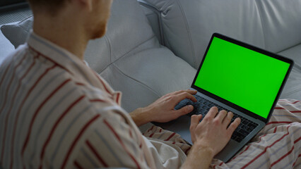 Freelancer browsing web green laptop screen closeup. Man shopping online weekend