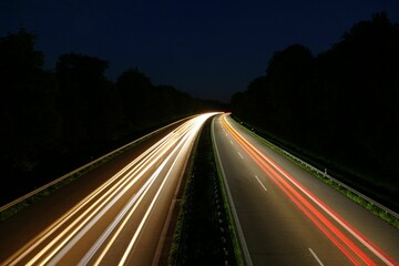 Long time exposure shows speed of cars from a Germahighway at night