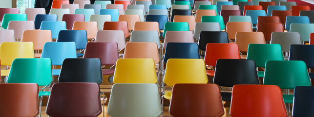 Colorful auditorium with simple seats in a row. Intense colors